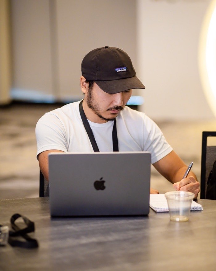 Kyler working at a laptop, taking notes
